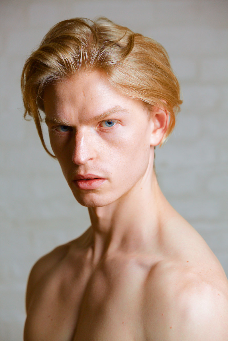Portrait of a blond male fashion model looking at the camera